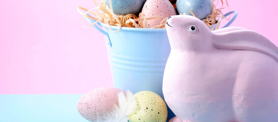 Cute Easter Bunny with bucket of eggs in pink and pale blue pastel colors, with copy space. Sized...