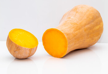 It stands with a cut pumpkin on a white background.