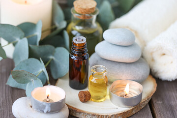 Fototapeta na wymiar Assortment of natural oils in glass bottles on wooden background. Concept of pure organic ingredients in cosmetology. Bath accessories, atmosphere of harmony, relax. Close up macro. Healthy lifestyle