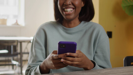 A beautiful lady is looking at something on the phone and smiling