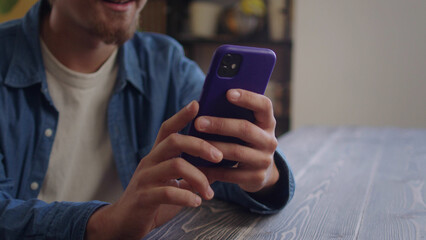 A handsome man is typing something on the phone