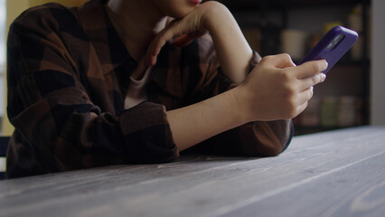 A young girl is watching something on the phone