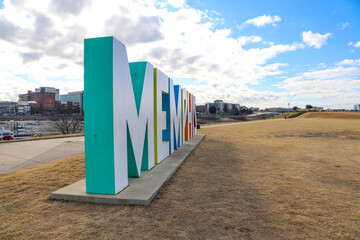 a gorgeous shot of the colorful Memphis sign with gorgeous blue sky and powerful clouds with yellow winter grass at Mud Island Park in Memphis Tennessee USA  - obrazy, fototapety, plakaty
