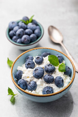 Cottage cheese with blueberry, fresh berries, keto healthy breakfast concept, top view.