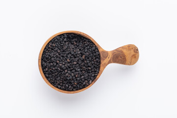 Bio natural black sesame seeds on wooden spoon.