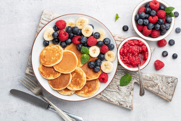 Keto diet pancakes made or almond flour, served with berries.