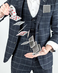 Man's hands showing trick with playing cards. Performance, show  at casino. Poker gambling game.
