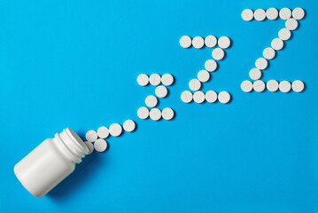 insomnia concept. sleeping pills in the form of z-z-z are scattered from a die
