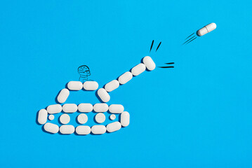 The concept of reducing pain. Analgesics. Pain killers. A tank lined with pills shoots a capsule