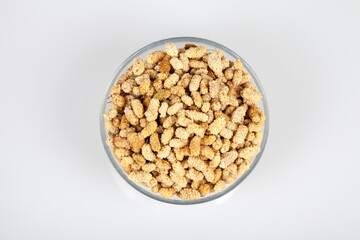 Dried mulberry in glass bowl on white background