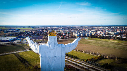 Jesus figure. At background Swiebodzin city in Poland. 