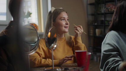 A beautiful lady is drawing halloween make-up