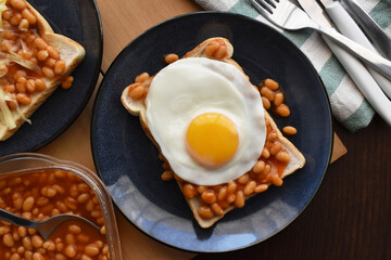 Egg and beans on toast. English breakfast style. Food from above concept. Flat lay top view food photography.