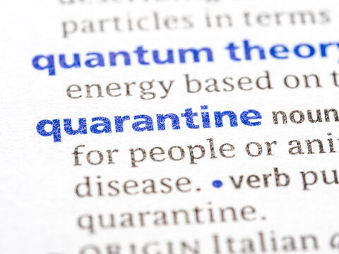 Quarantine - English dictionary definition of the word - photo of a dictionary page with paper grain texture - selective focus on the word