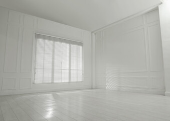 Fototapeta premium Empty room with white walls, large window and wooden floor