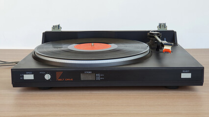 Obraz premium vintage record player isolated on wooden background. Music on vinyl records.