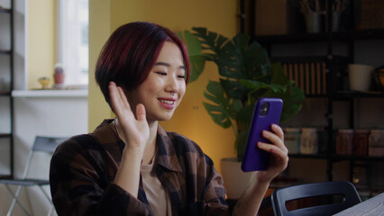 A young lady is talking with someone on the phone