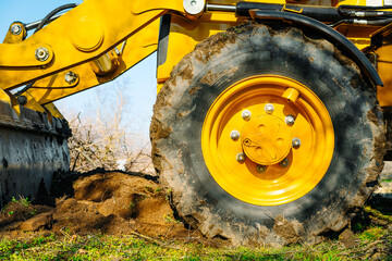 Excavator wheel on field