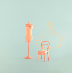Sewing form and vintage chair, minimal arrangement against pastel blue background. Fashion designer creative layout. 