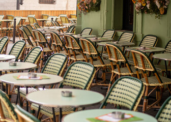 Tables and chairs on patio terrace on street in France
