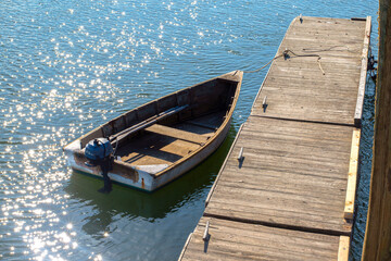 row boat sitting idle on calm seas