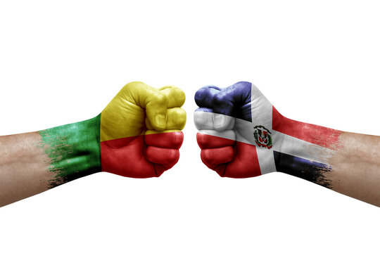 Two hands punch to each others on white background. Country flags painted fists, conflict crisis concept between benin and dominican republic