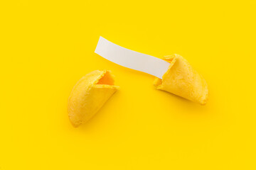 Broken Chinese fortune cookie with blank slip outside