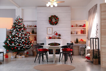 Cozy dining room interior with Christmas tree and festive decor
