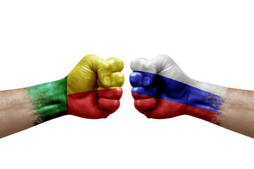 Two hands punch to each others on white background. Country flags painted fists, conflict crisis concept between benin and russia