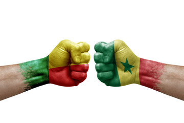 Two hands punch to each others on white background. Country flags painted fists, conflict crisis concept between benin and senegal - obrazy, fototapety, plakaty