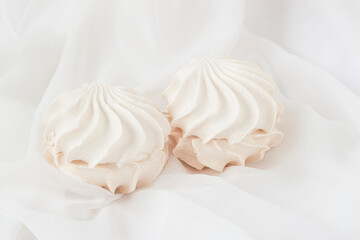 Fototapeta na wymiar Couple of meringue marshmallows, sweet homemade zephyr