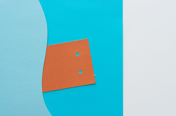 tag with holes on blue paper with wavy element