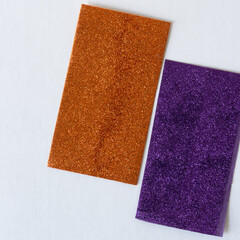 Fototapeta premium brown orange and deep purple glitter paper on a light background