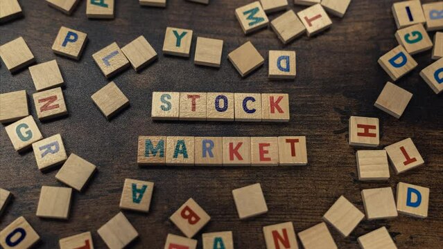 Stock market words spelled from wooden block letters - zoom in shot. High quality 4k footage
