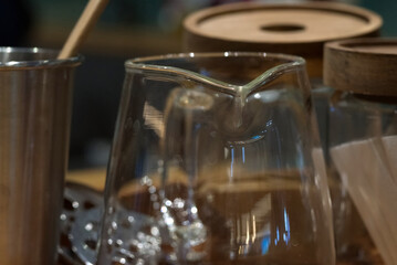 A transparent glass cup on a wooden table with blur background