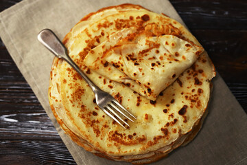 Selective focus. A stack of pancakes on a platter.
