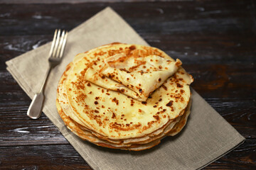 Selective focus. A stack of pancakes on a platter.