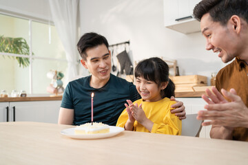 Asian attractive happy family celebrate birthday for girl kid in house.