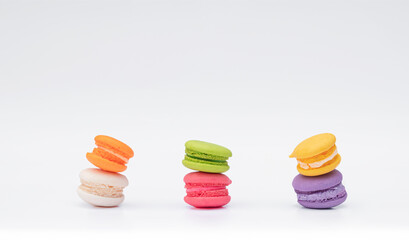 Stack of mini colorful various tasty macarons on white background