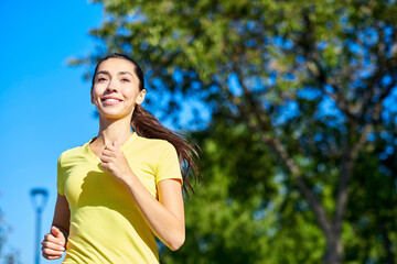 Running woman. Female Runner Jogging during Outdoor Workout in a Park. Beautiful fit Girl. Fitness model outdoors.