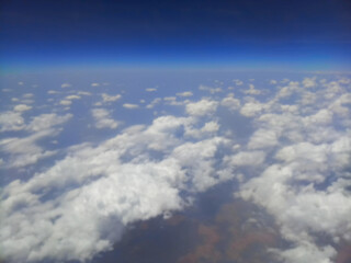 Blurred image of nice white clouds in the atmosphere, image shot in the sky from aeroplane. Nature stock image.