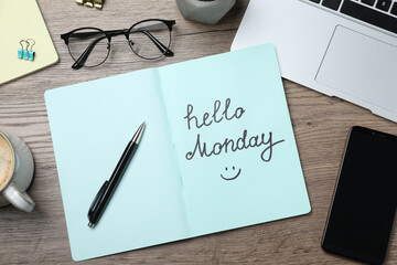 Message Hello Monday written in notebook, office stationery and smartphone on wooden desk, flat lay