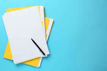 Yellow files with blank sheets of paper and pen on turquoise background, top view. Space for text - Powered by Adobe