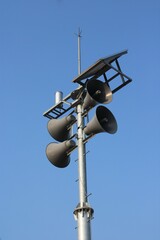 Outdoor loudspeaker system, against clear blue sky