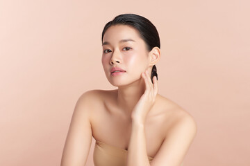 Beautiful young asian woman with clean fresh skin on beige background, Face care, Facial treatment,...