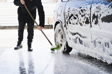  Car cleaning service. The man washing his car on self-service car. Express Car Wash