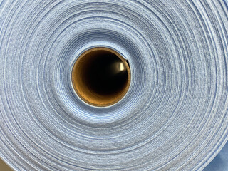 Fototapeta na wymiar Round roll of blue felt.Sale of soft fabric for designers.