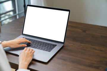 Fototapeta na wymiar Business women hand using laptop and type on the keyboard. Mockup screen of advertisement.