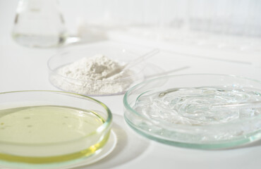 laboratory petri dishes with growth medium or culture medium and powder on a table. cosmetic...
