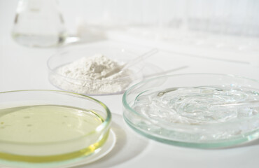 laboratory petri dishes with growth medium or culture medium and powder on a table. cosmetic testing in a lab, making ingredients safe.